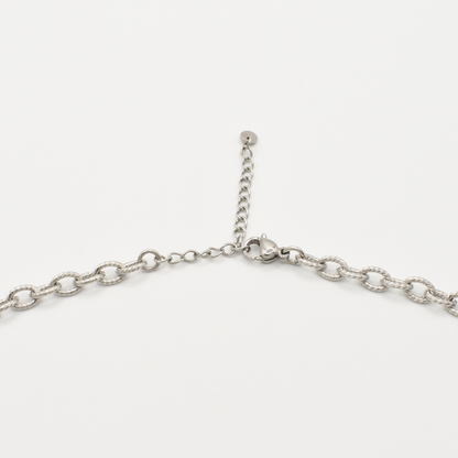 A close-up of the Salty Dreamers Necklace | Paua Shell Hau, a handmade stainless steel piece with lobster clasp and adjustable extension chain, shown on a white background.